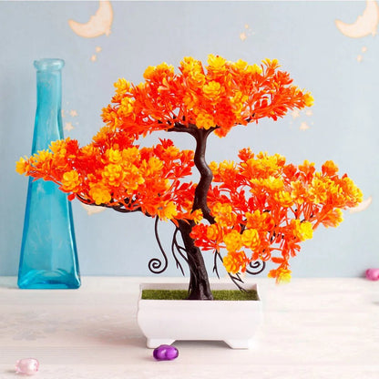Bonsái artificial en maceta de tamaño pequeño para decoración de hogar, con follaje verde y maceta negra.