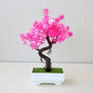 Bonsái artificial en maceta de Nexorretail, árbol pequeño decorativo para hogar y jardín, con follaje verde y maceta negra.